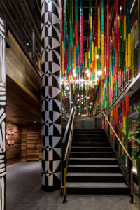 The entry to Nando's Michigan Avenue location in Chicago, IL featuring a light installation by Tulsha Booysen made from recycled cans
