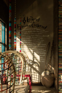 Hanging chairs are dappled with morning light at Nando's Lakeview location in Chicago, IL
