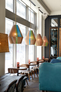 colorful fiber light fixtures line the windows at Nando's Bay Street in Toronto, Canada.